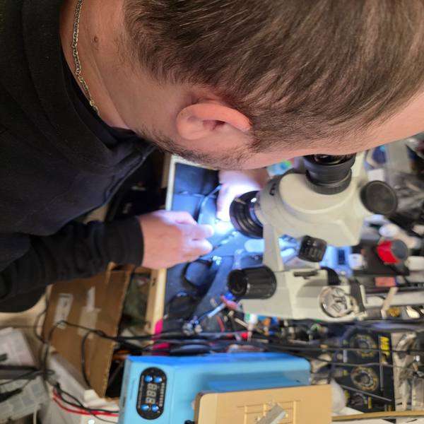 Ray-Ban Meta electronics repair under microscope